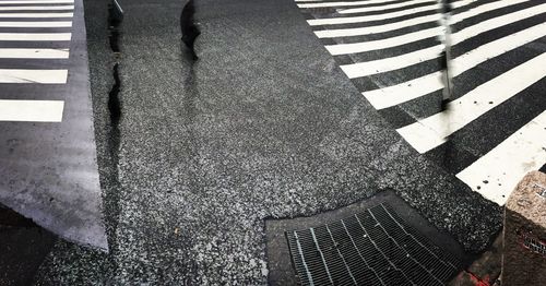 Low section of person walking on road