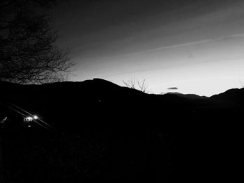 Silhouette landscape against clear sky at night