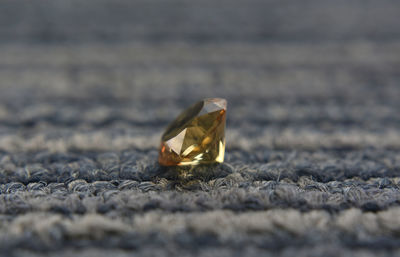 Close-up of wedding rings on ground