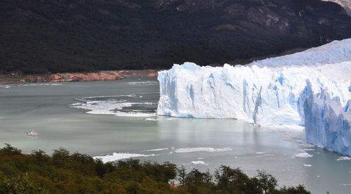 Scenic view of sea with mountain range in background