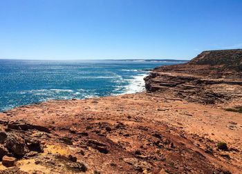 Scenic view of beach against blue sky