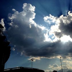 Low angle view of street light against cloudy sky