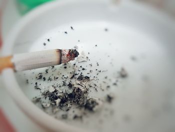 Close-up of cigarette in ashtray