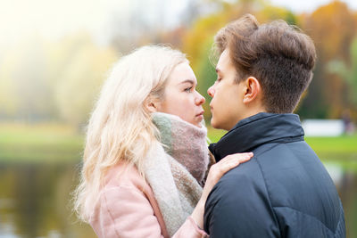 Close-up of young couple embracing at park