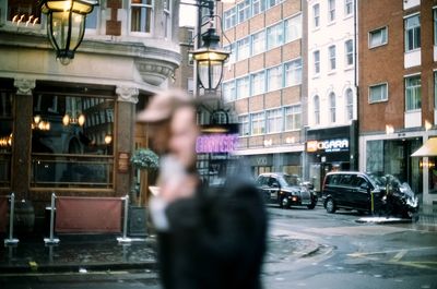 Person photographing on street in city