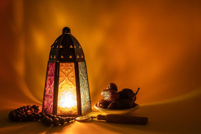 Close-up of illuminated lighting equipment on table