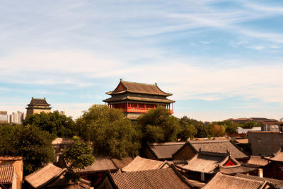 Temple by building against sky