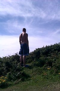 Full length of man walking on field against sky