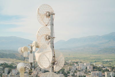 Rear view of man standing on mountain against sky