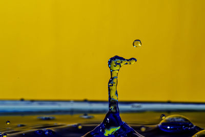 Close-up of drop falling on water