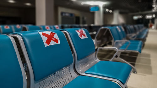 Close-up of chairs against blue wall