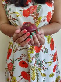 Midsection of woman holding fruits