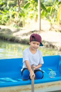 Boy sitting in swimming pool