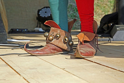 Low section of person wearing antique shoes during festival