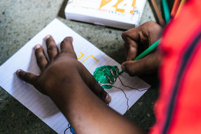 High angle view of woman hand holding paper