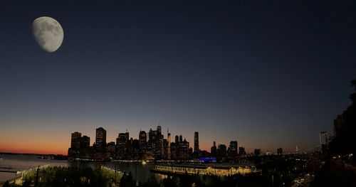 Modern buildings against sky at night