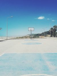 Empty basketball court against blue sky