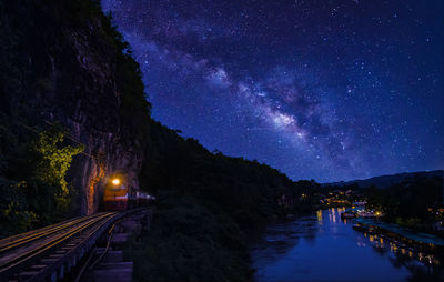 Panoramic view of illuminated bridge against sky at night