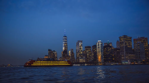 Illuminated city at waterfront