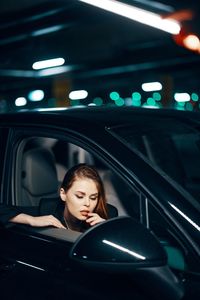 Young woman with eyes closed in car