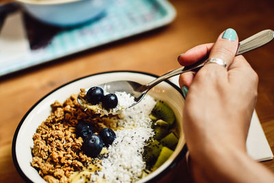 Midsection of person holding ice cream in bowl