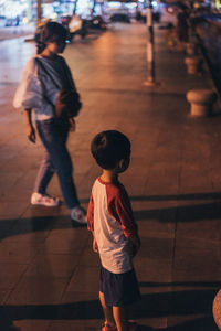 Rear view of people walking on street