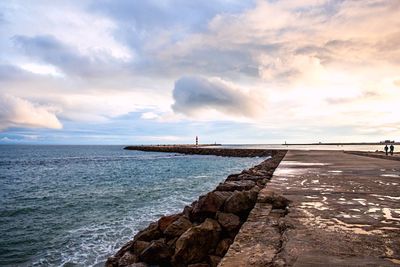 View of calm sea against cloudy sky