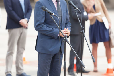 Midsection of speaker giving speech