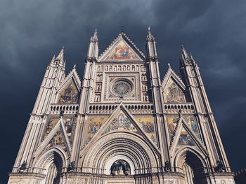 Low angle view of building against cloudy sky