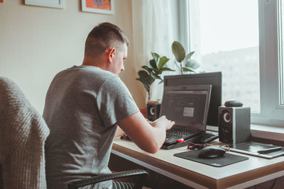 Man working on laptop at home