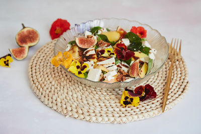 Autumn dinner recipe - vegetarian salad with mango, feta, edible flowers, figs, peach, basil 