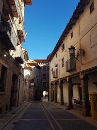 Narrow alley amidst buildings in city