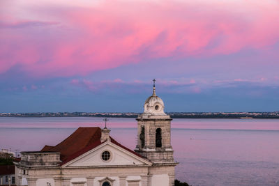 Church of santa luzia e sao bras with pink cloud during sunset