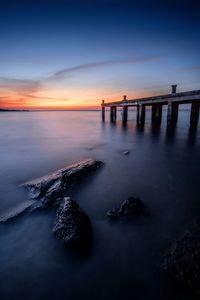 Scenic view of sea against sky at sunset