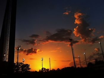 Silhouette trees against sky at sunset