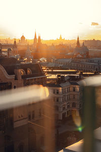 High angle view of buildings in city during sunset