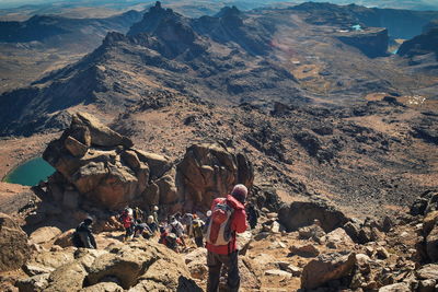A group of hikers in the panoramic volcanic mountain landscapes of mount kenya, kenya