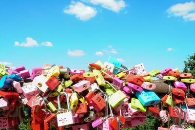 Close-up of multi colored objects against blue sky