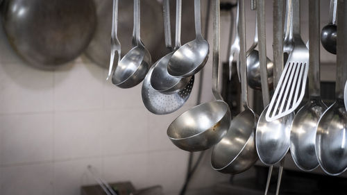 Restaurant kitchen utensils hanging, italy.