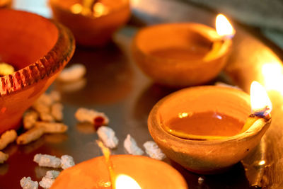 Close-up of illuminated diyas