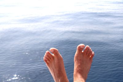 Low section of man relaxing in water