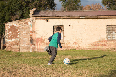 Boy playing soccer outdoors