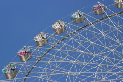 Low angle view of ferris wheel against sky