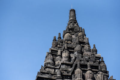 Low angle view of temple building against clear blue sky