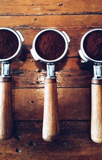 Coffee grounds in portafilter on wooden table