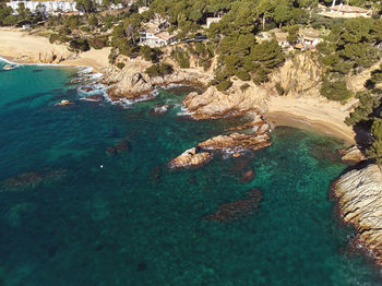 High angle view of rocks on sea shore