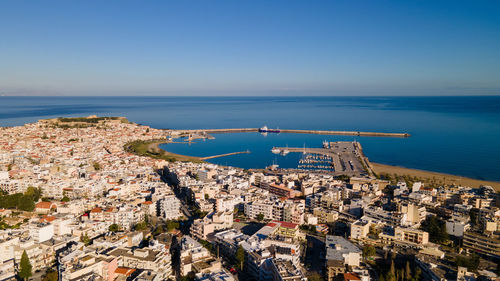 High angle view of city rethymno in crete, by sea against clear sky