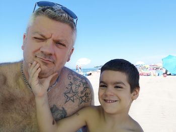 Portrait of father and son at beach