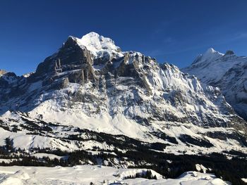 Scenic view of snowcapped mountains against clear sky