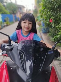 Side view of young woman holding car